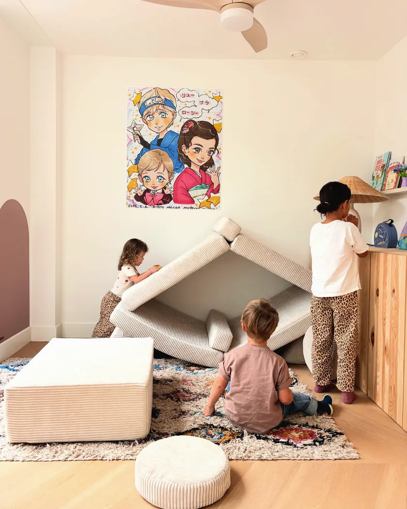 Two children sitting together on the corduroy play sofa in Vanilla