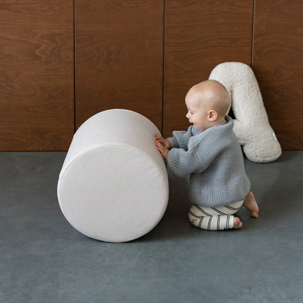 Child developing motor skills and problem-solving abilities while playing with Shappy modular play sofa