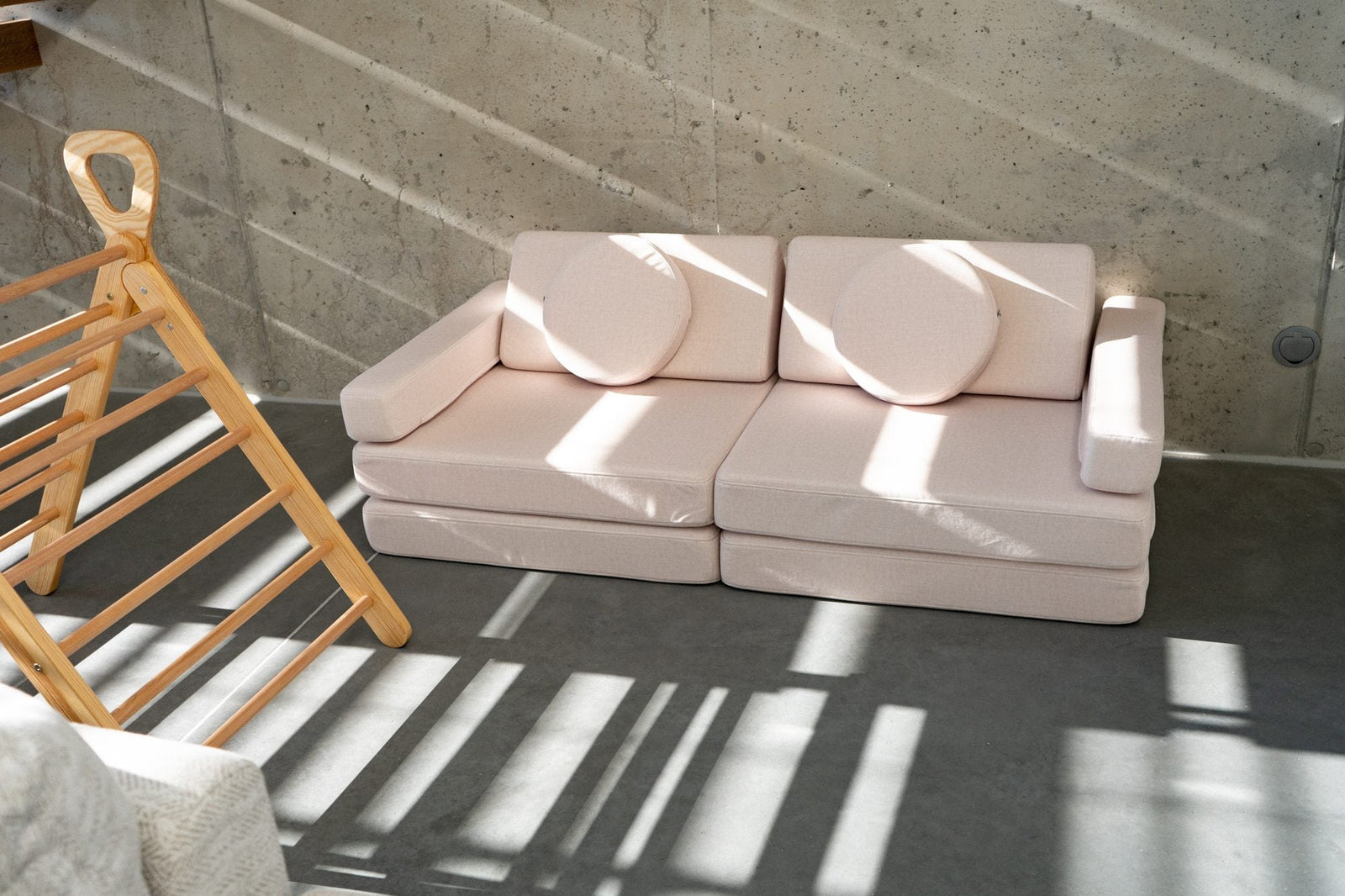 Light pink play sofa in a sunlit room