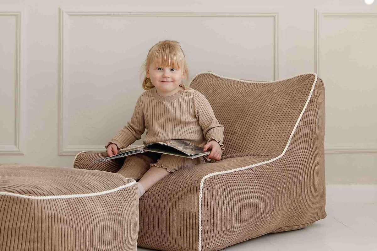Young girl sitting in Kumo Chair with the Ottoman
