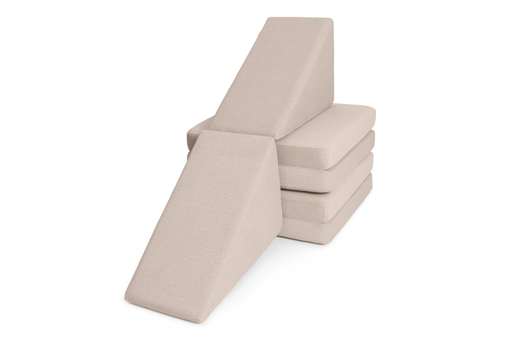 Two Slides in Soft Beige on a stack of base cushions