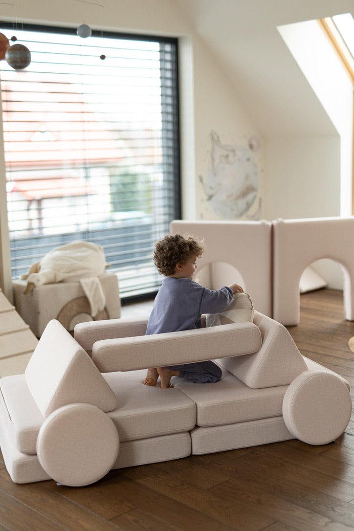 Child playing on a SHAPPY modular play sofa at home