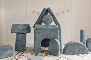 A play castle built from soft modular shapes and add-ons.