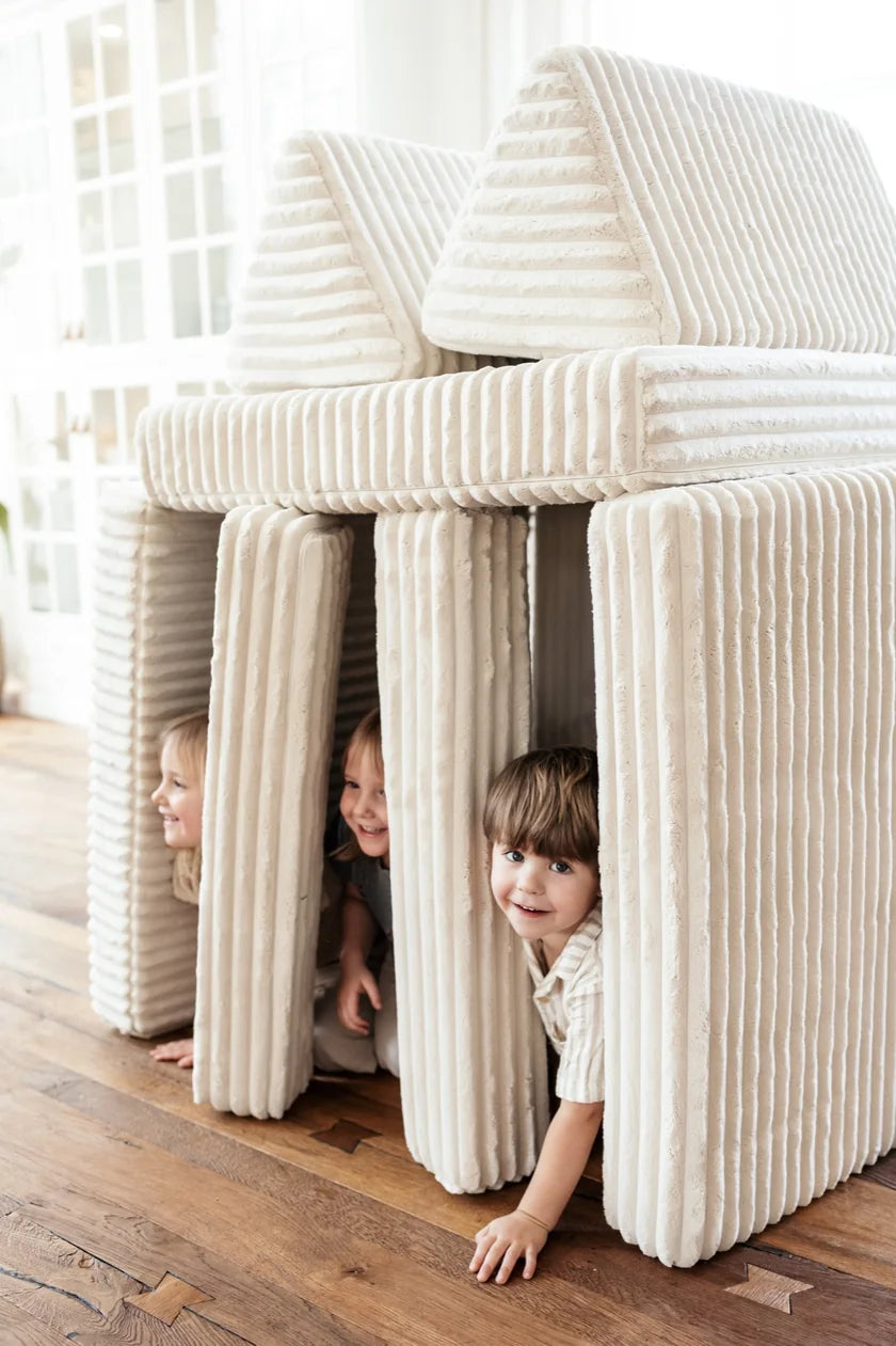 Three children inside a playhouse built from Play Sofa Waffle