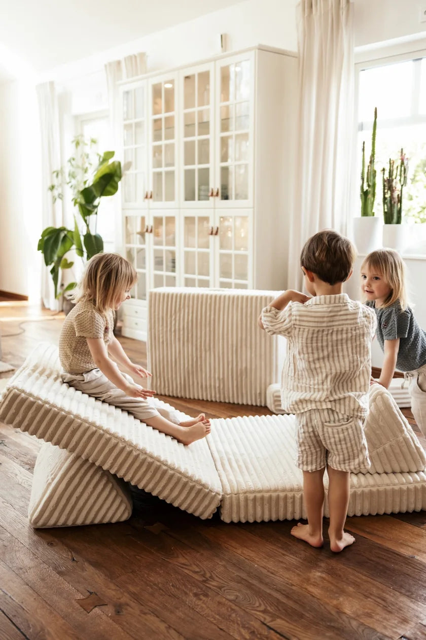 Children playing on a ramp built from Play Sofa Waffle