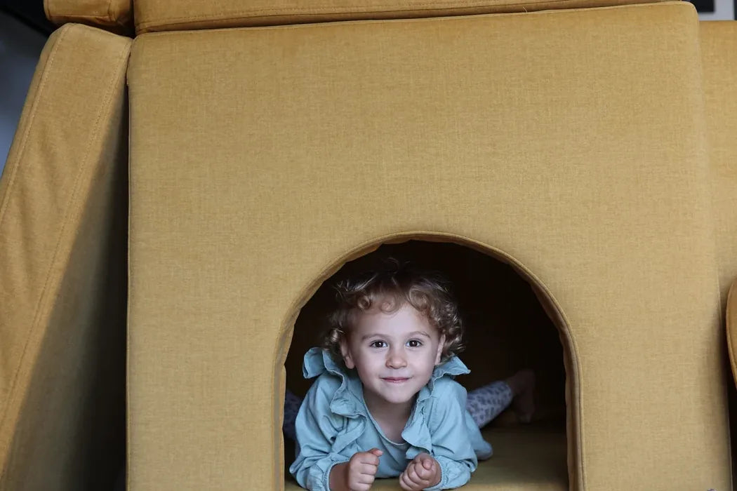 Child looking out of the doorway of a castle built with Arches in Mustard