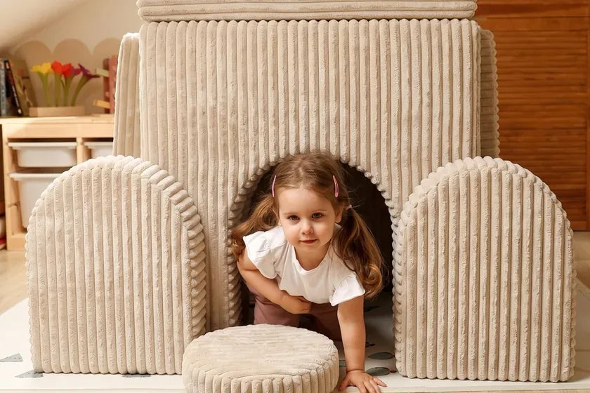 Child crawling out of a castle built with Arches Waffle in Cream Beige