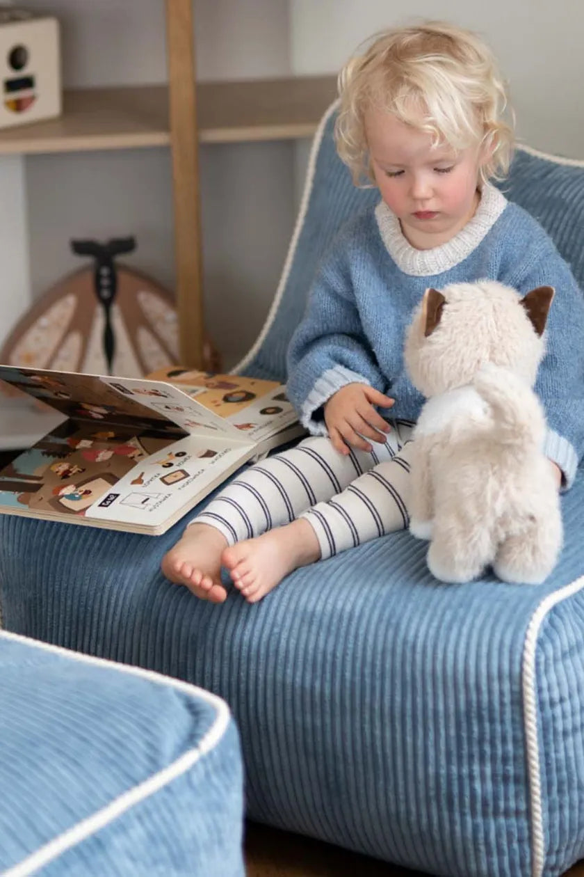 Child reading in Kumo Chair Sky Sugar