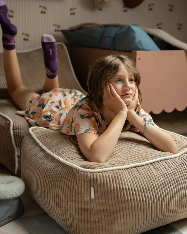 Girl lying on Kumo Ottoman