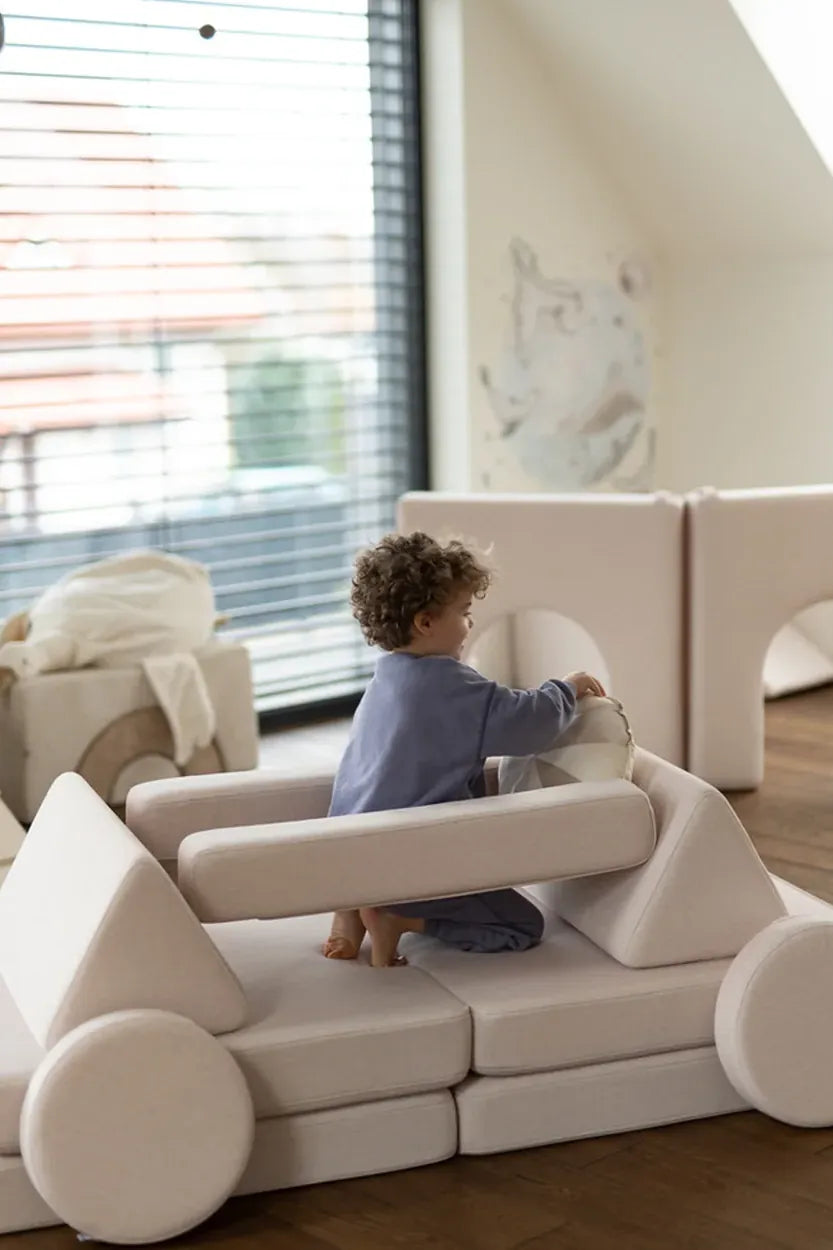 Child building a car from Play Sofa Original Soft Beige