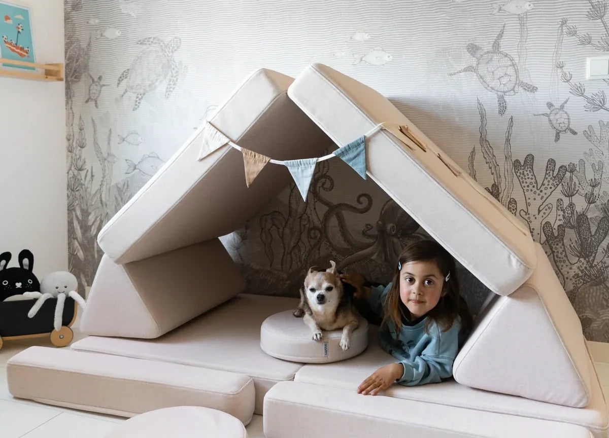 Child and dog in a den built from Play Sofa Original Soft Beige