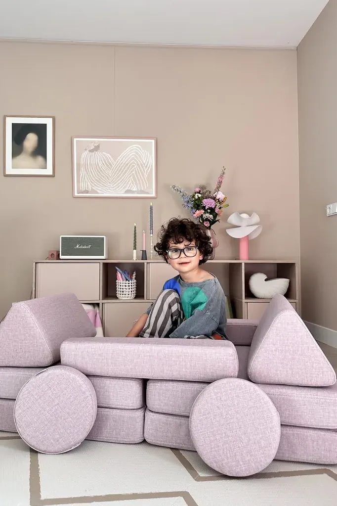 Child sitting in a car built from Play Sofa Original Mini in Soft Pink