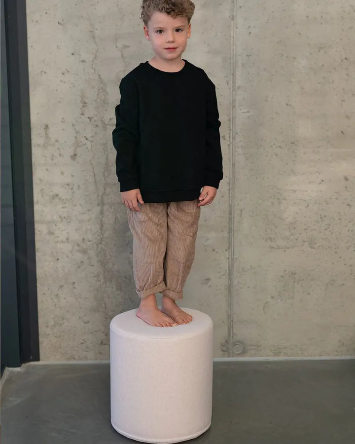 Boy standing on Shappy Pouf Ultra Plush