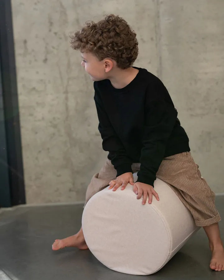 Boy rolling Shappy Pouf Ultra Plush on its side