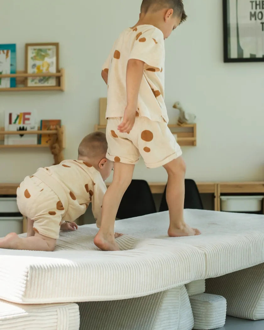 Twee kinderen op een podium van onderdelen van de speelbank van Corduroy