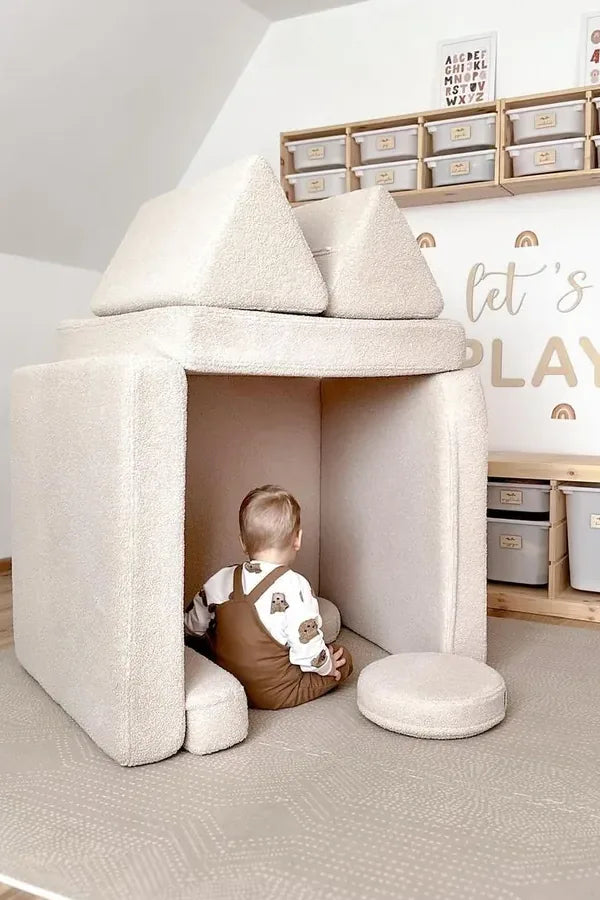 Toddler inside a little house built from Play Sofa Original Teddy