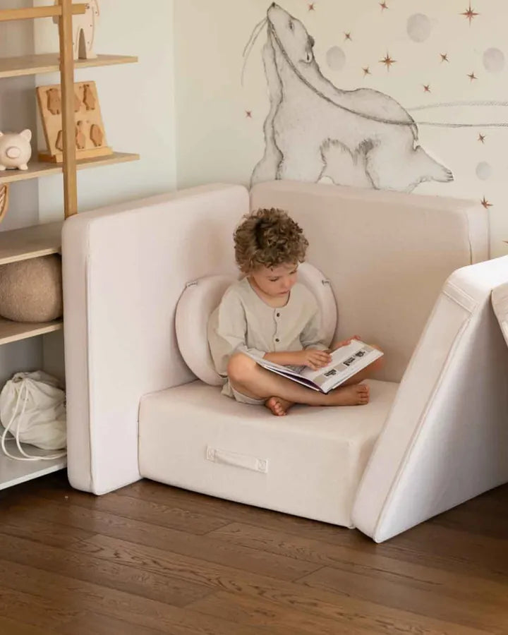 Boy reading in a chair built with the Trampoline and Play Sofa Original