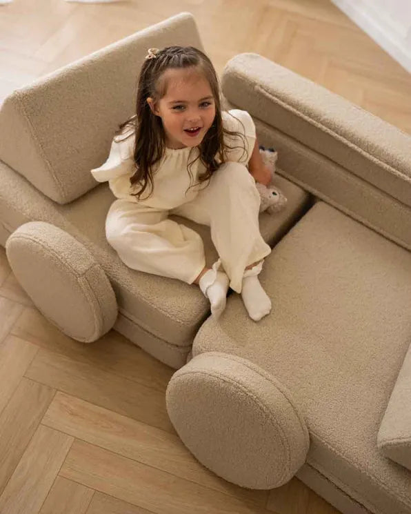 Girl sitting in Play Sofa Original Teddy Light Beige