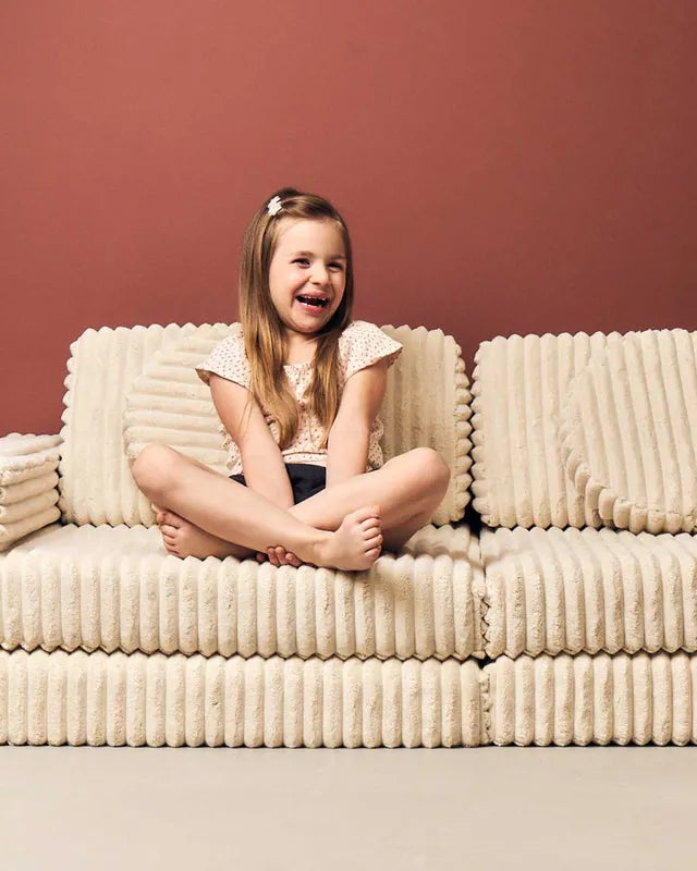 Girl sitting on Play Sofa Pure Corduroy Waffle Cream Beige