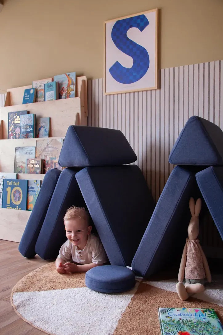 Toddler inside a hideaway built from Play Sofa Original Mini in Navy Blue