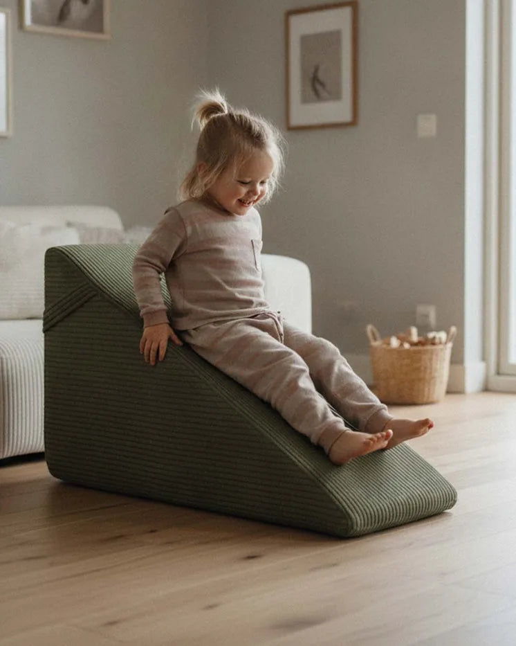 Child sliding down the Slide Corduroy in Dusty Sage