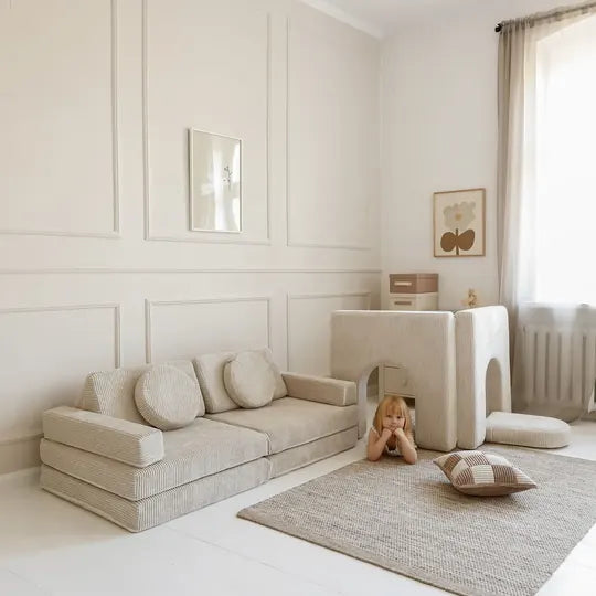 Play Sofa with an Arches playhouse in Vanilla corduroy, girl lying on the rug