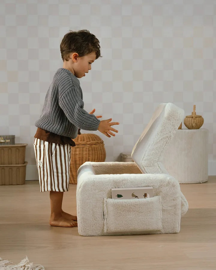 Boy lifting Lumi Chair Bunny in Toffee