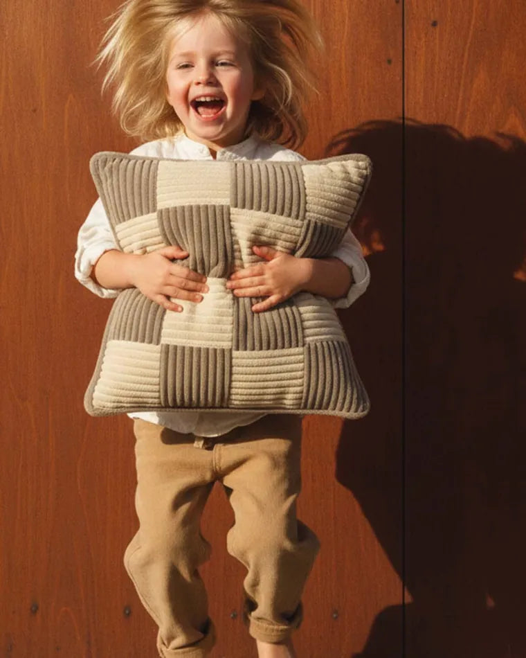 Child hugging a Check Cushion