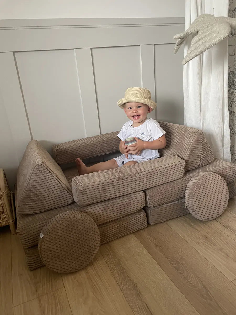 Toddler sitting in a car built from Play Sofa Pure Corduroy Mini in Chocolate