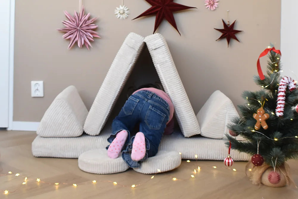 Child playing in a den built from Play Sofa Pure Corduroy Mini in Vanilla