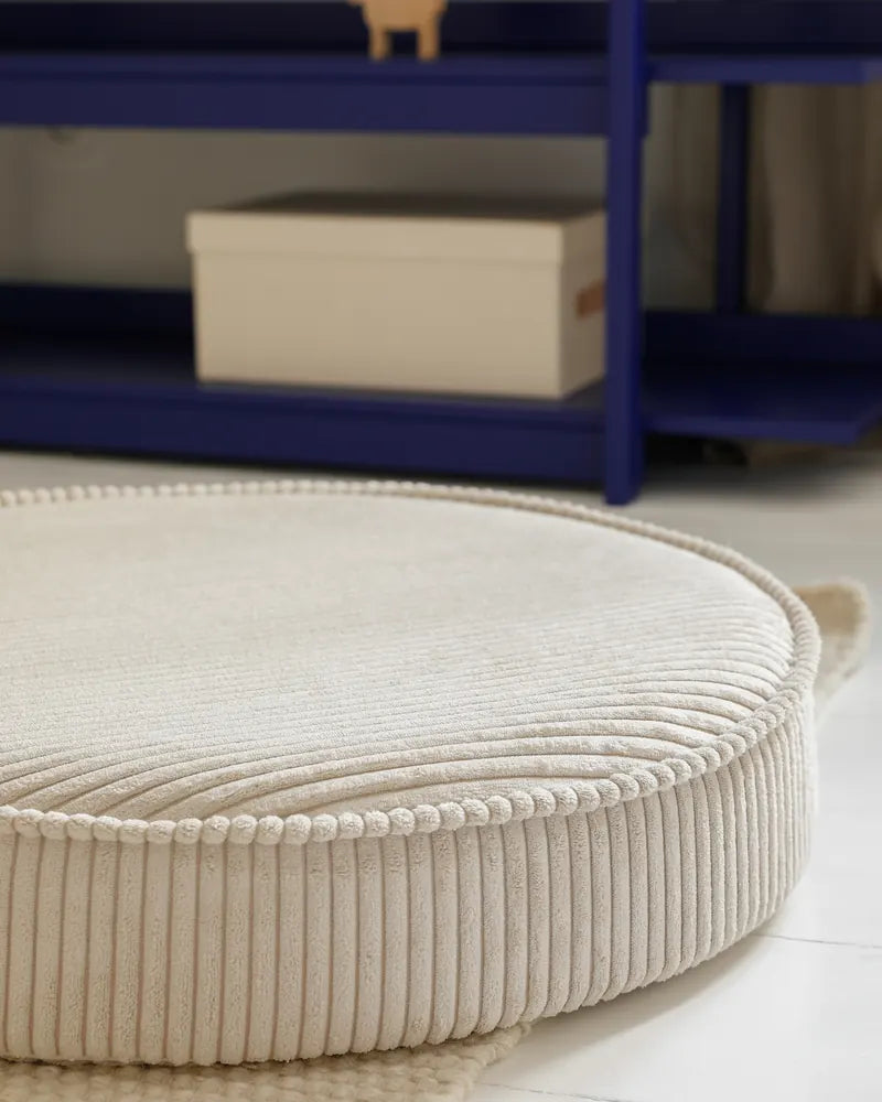Close-up of the Yuka Pouf corduroy and piping in Vanilla